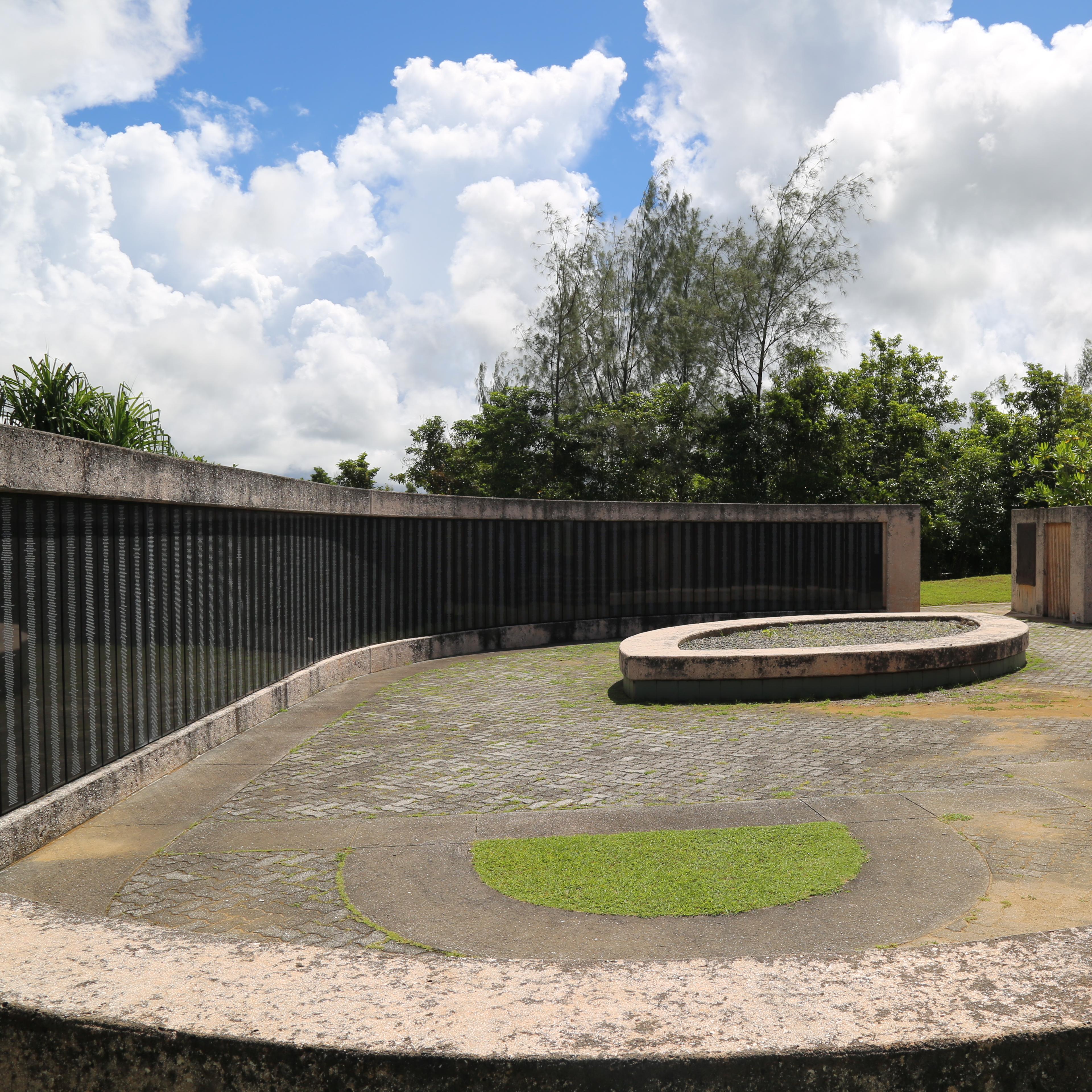 A memorial with names carved into shiny black panels
