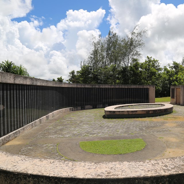 A memorial with names carved into shiny black panels