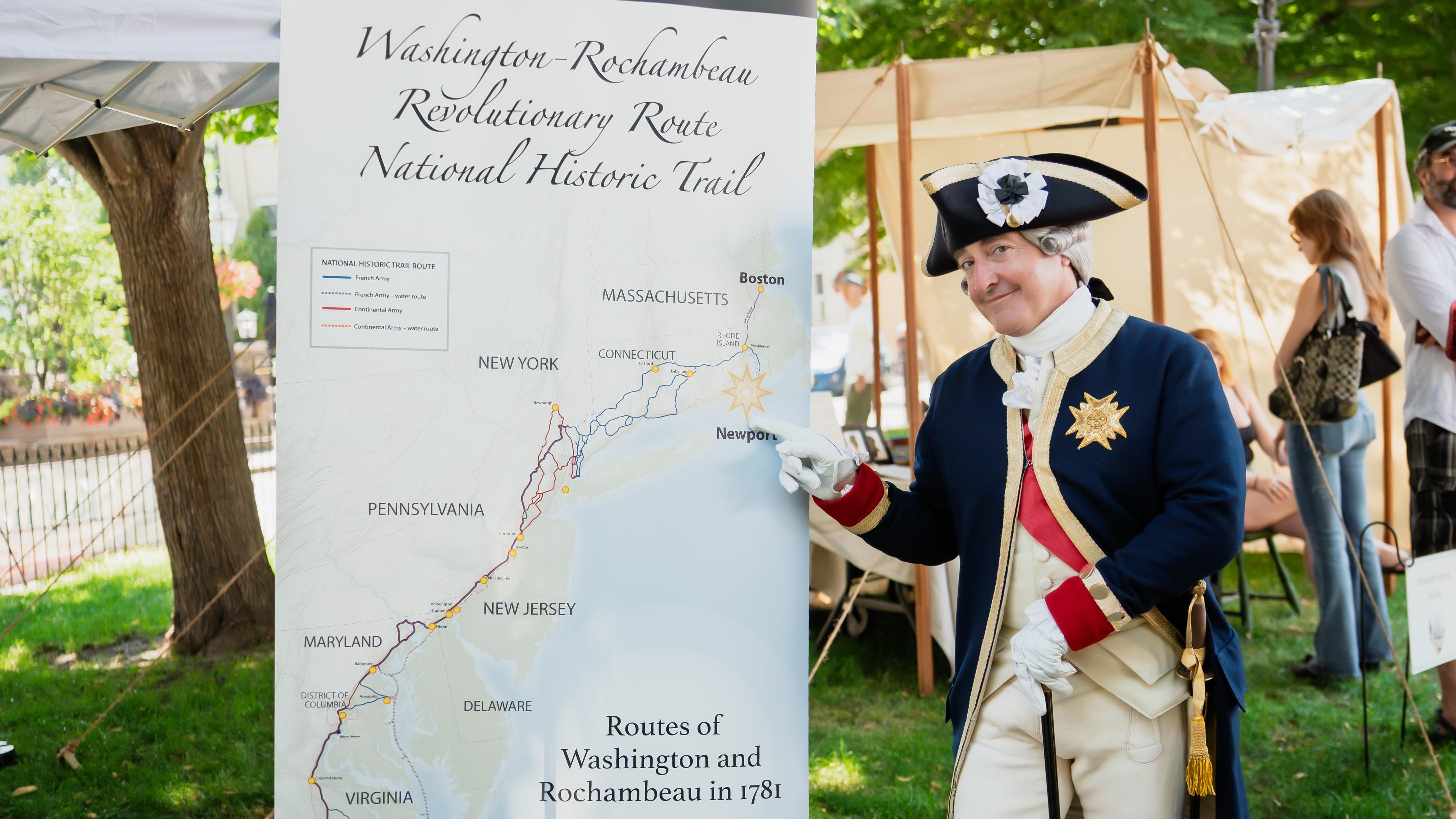 A living history interpreter portraying General Rochambeau points to a map of the historic trail.