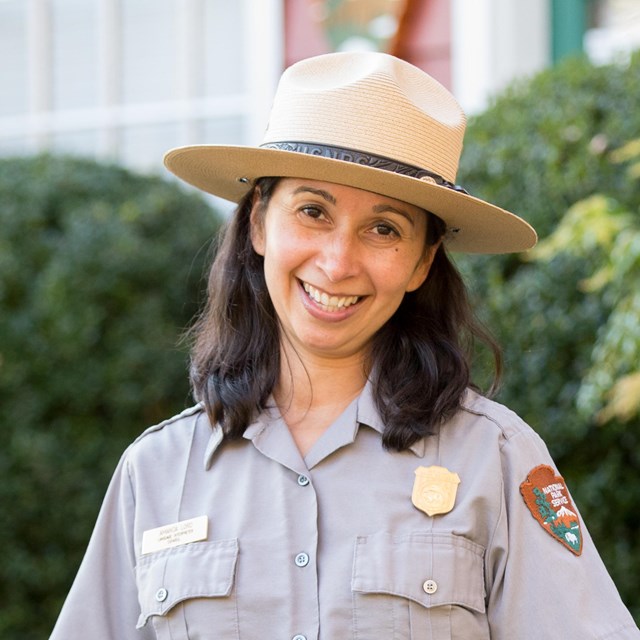 A park ranger smiles 