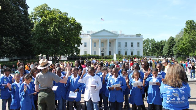 Ranger facing the White House with school children