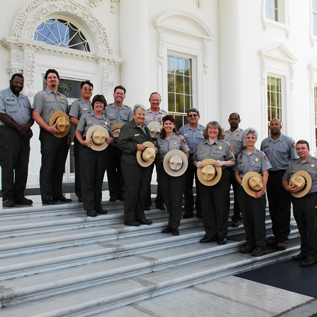 A group photo of some of the Park Rangers in front of the White House. 