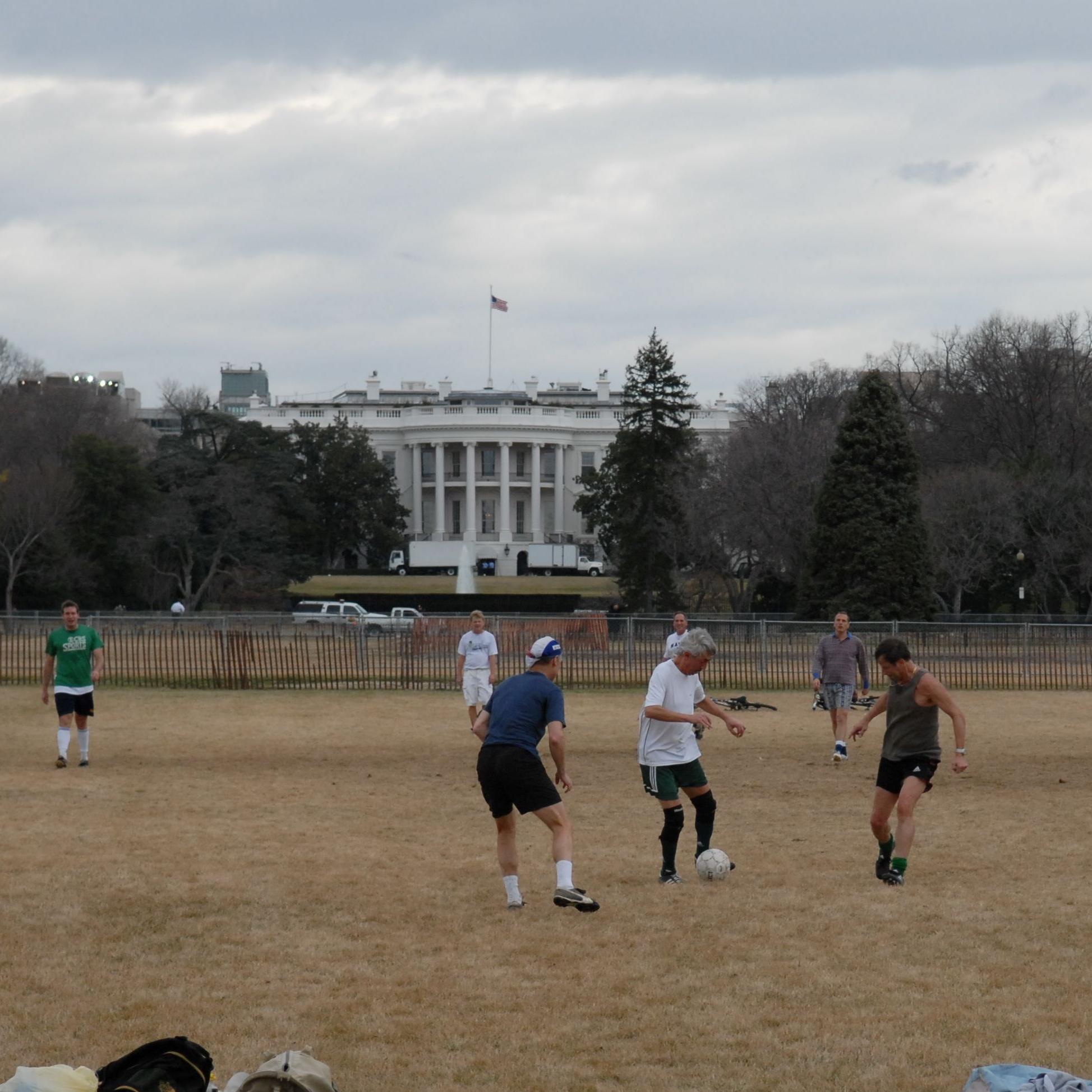 People play soccer on the Ellipse with a view of the White House in background