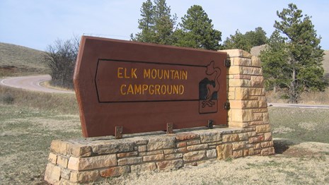 The entrance sign to the campground which reads "Elk Mountain Campground".