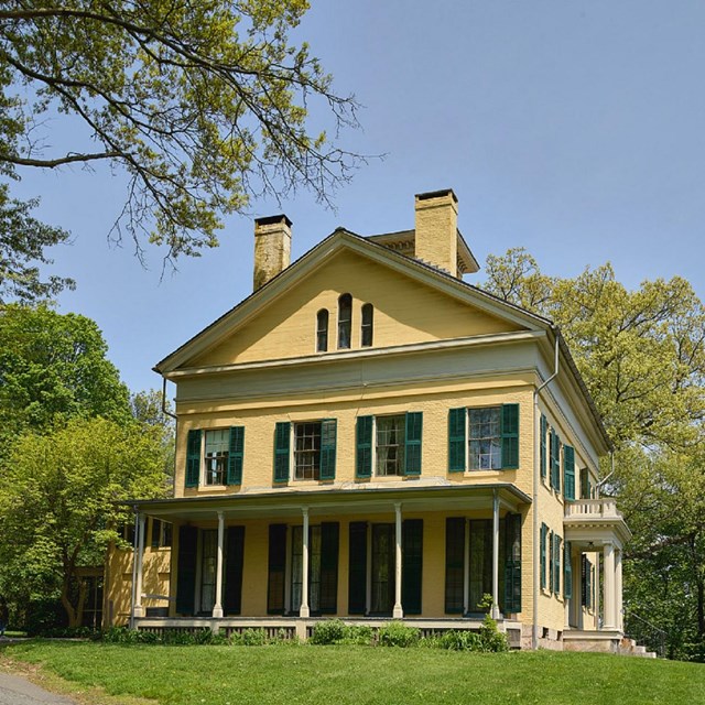 Yellow house against blue sky