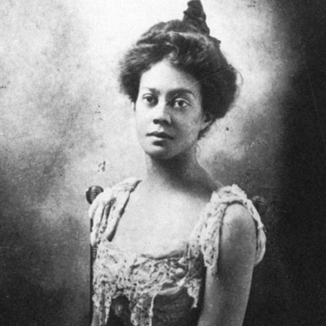 Black and white portrait of young black woman with hair in a bun