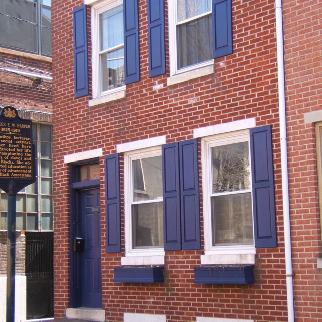 Brick building with blue shutters