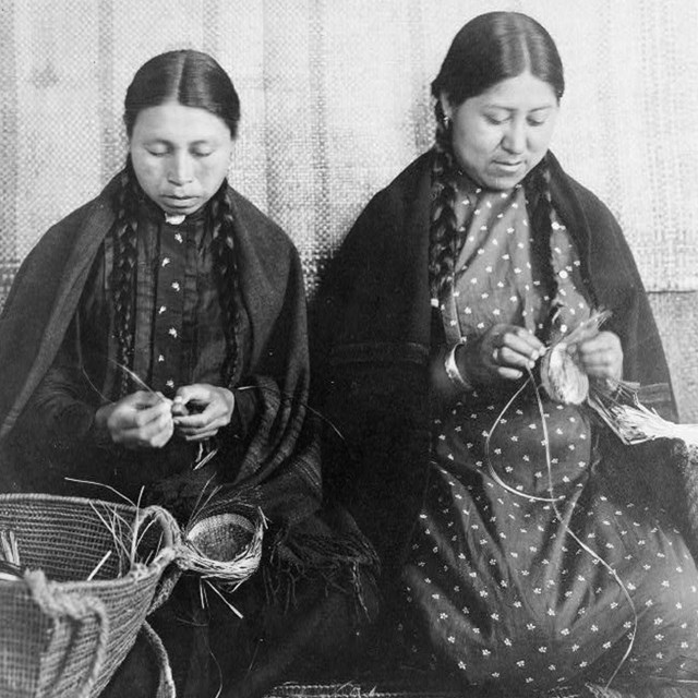 Woman measuring clothes on a manikin. NPS photo. 