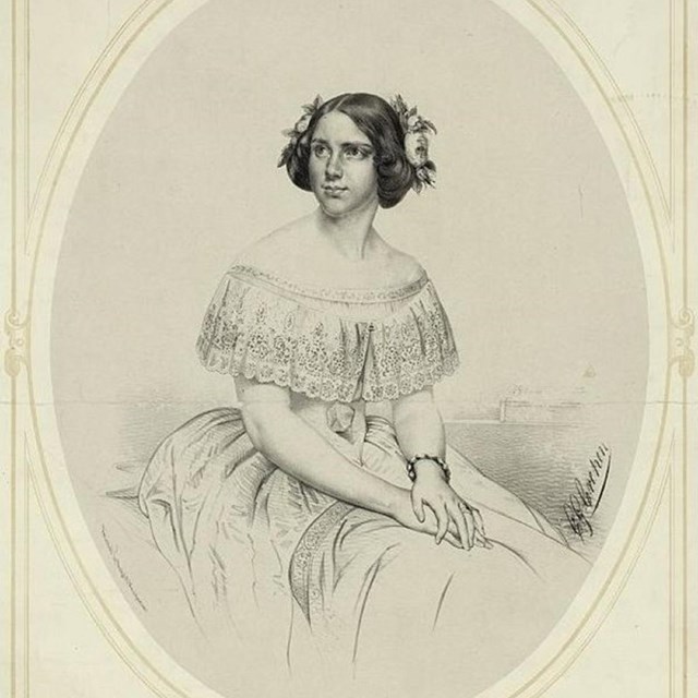 Portrait of woman in dress with flowers in her hair