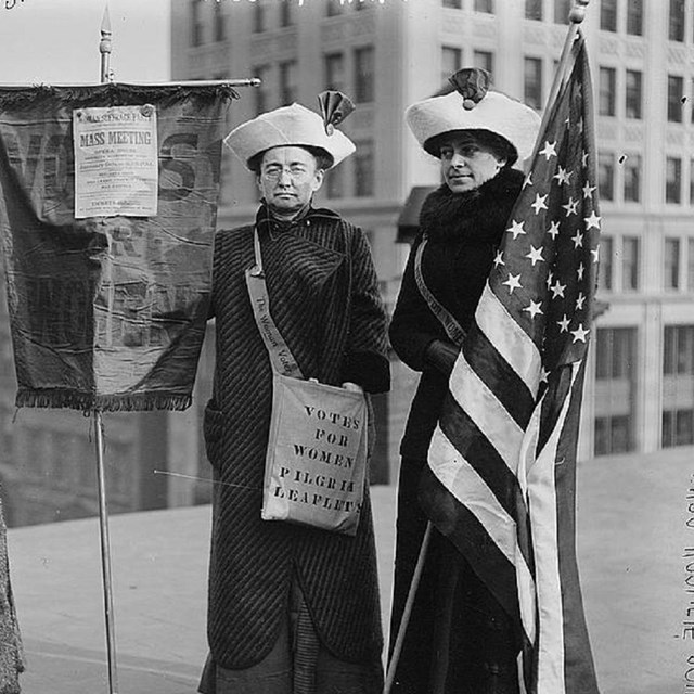 Group of women holding banners. 