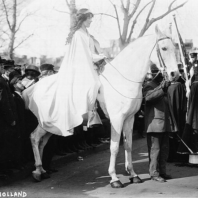 Black and white photo of Inez Milholland on a white horse. LOC