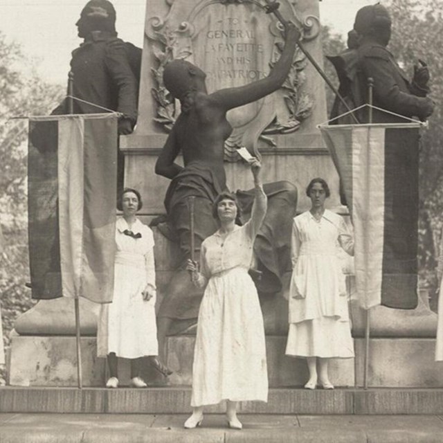 Black and white photo of women burning Wilson's speech in Lafayette Park