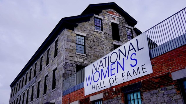 A large stone building with a sign reading "National Women's Hall of Fame"