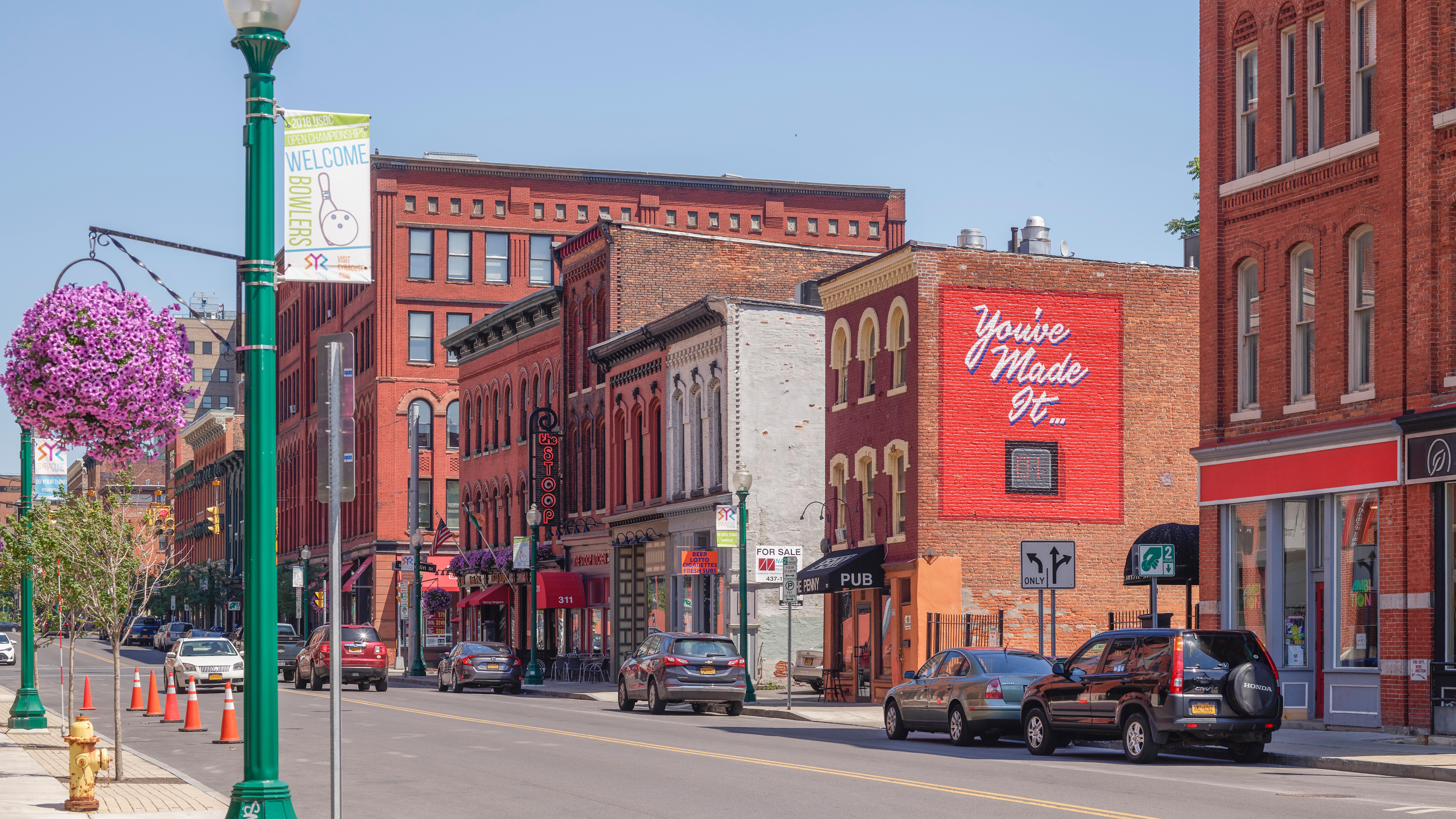 A city street with red brick buildings.