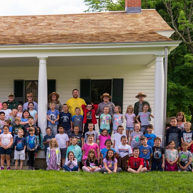A large group of students pose on the Stanton House porch