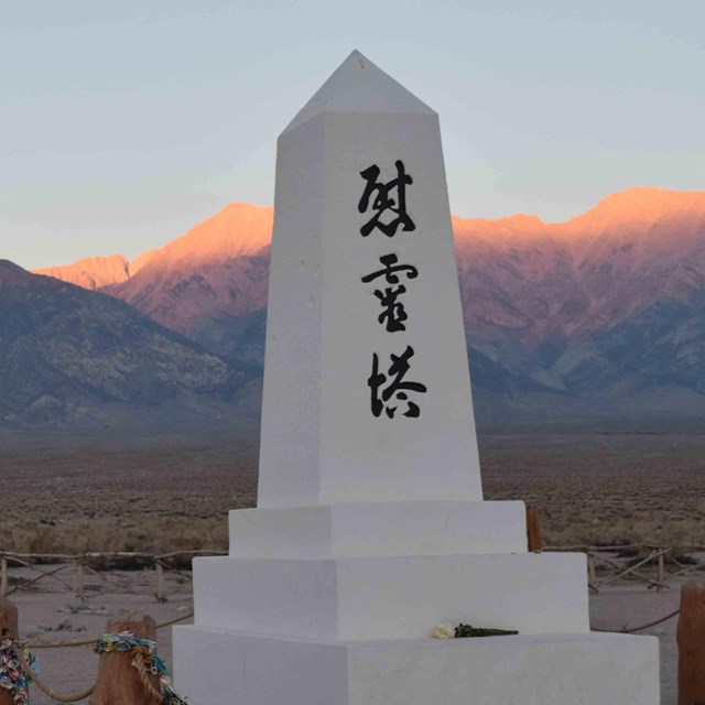 sunset, an marble obelisk on the right with japanese characters