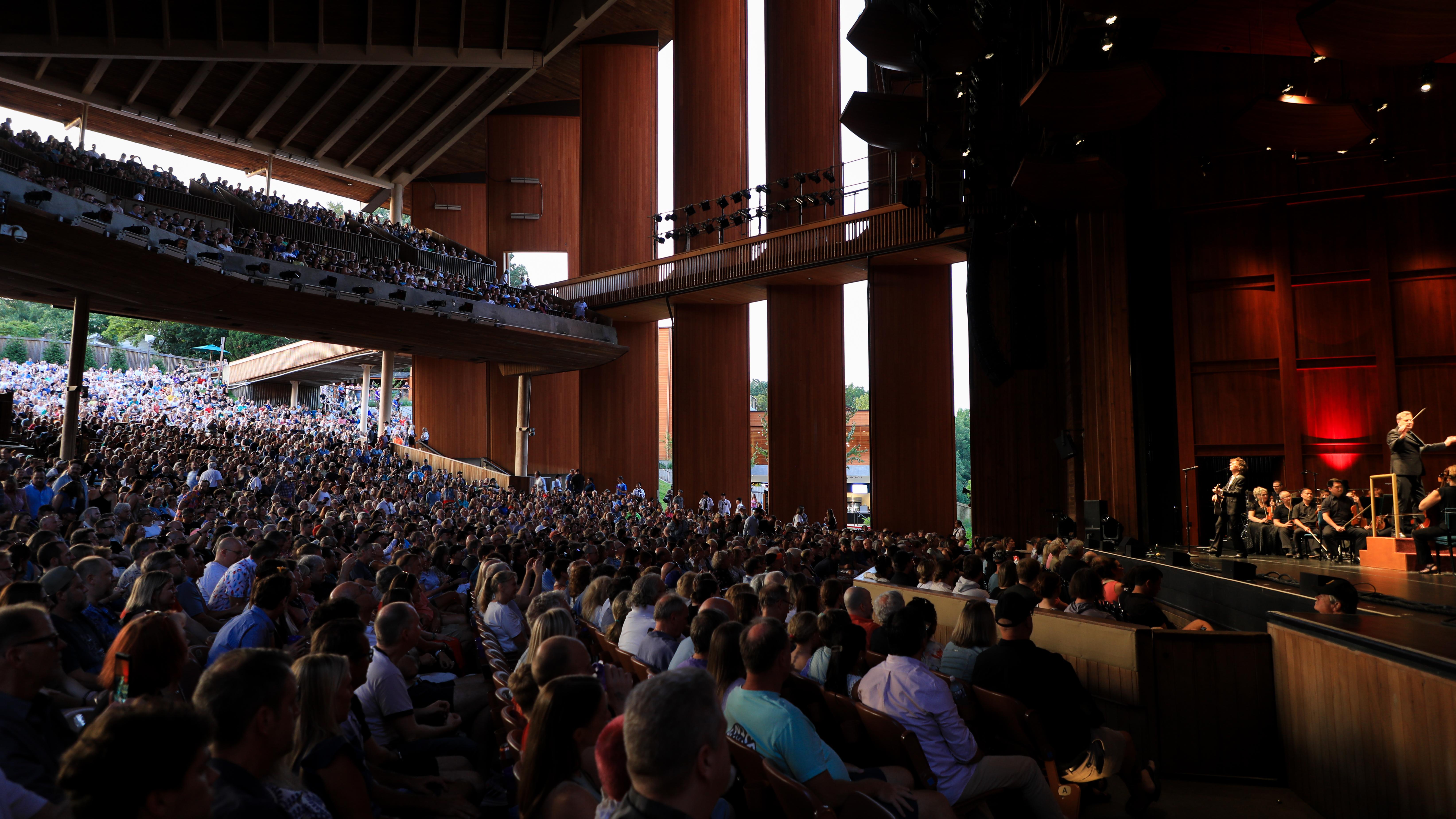 The seating area of the Filene Center with seated patrons