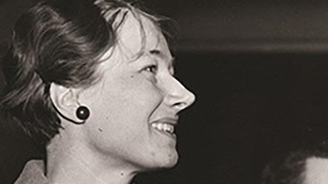 Portrait of Federica de Laguna holding a handbag and paper. 