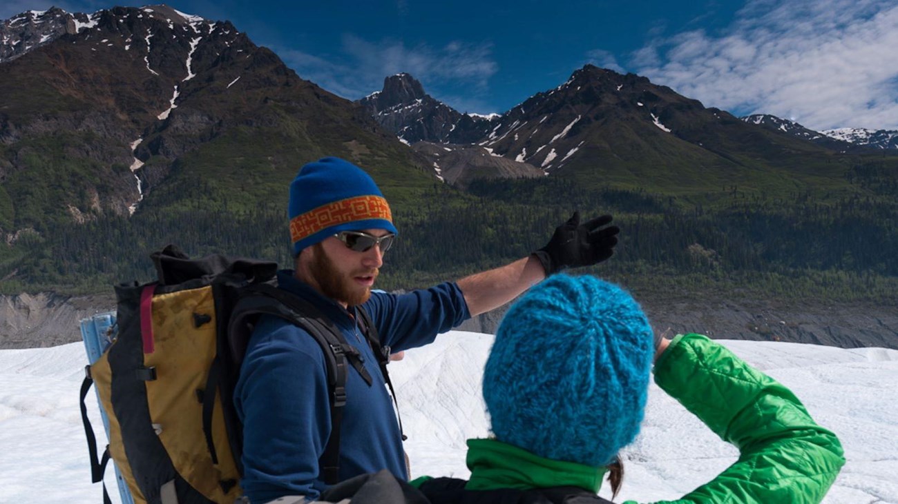 A guided glacier hike with a lead speaking.