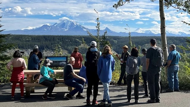 Ranger guiding a tour with Mt. Drum in the distance