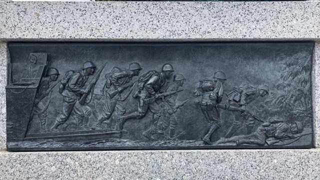 Sculpture showing troops storming a beach 