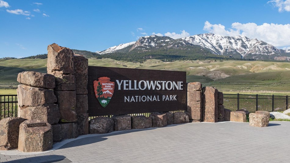North Entrance sign with mountains in the background