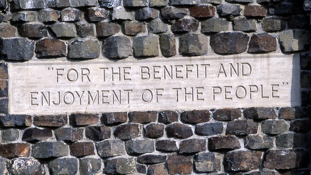 "For the benefit and enjoyment of the people" etched in concrete and surrounded in stone
