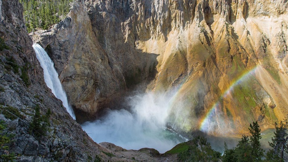 Water cascades over a cliff into a canyon