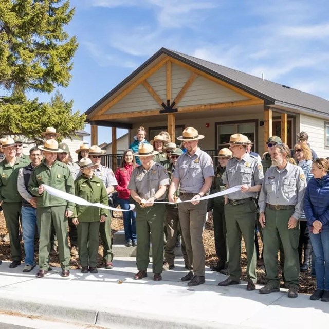 a group of National Park Service employees in front of brand-new housing