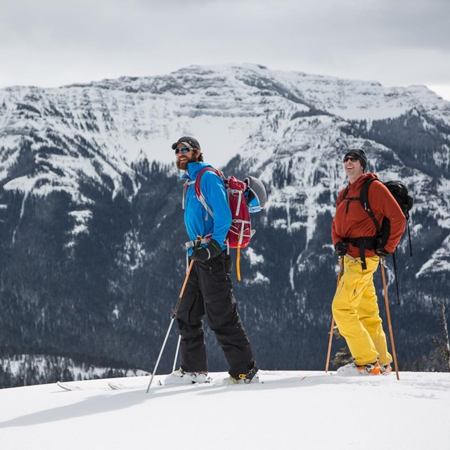 Two skiers explore the mountains of Yellowstone.
