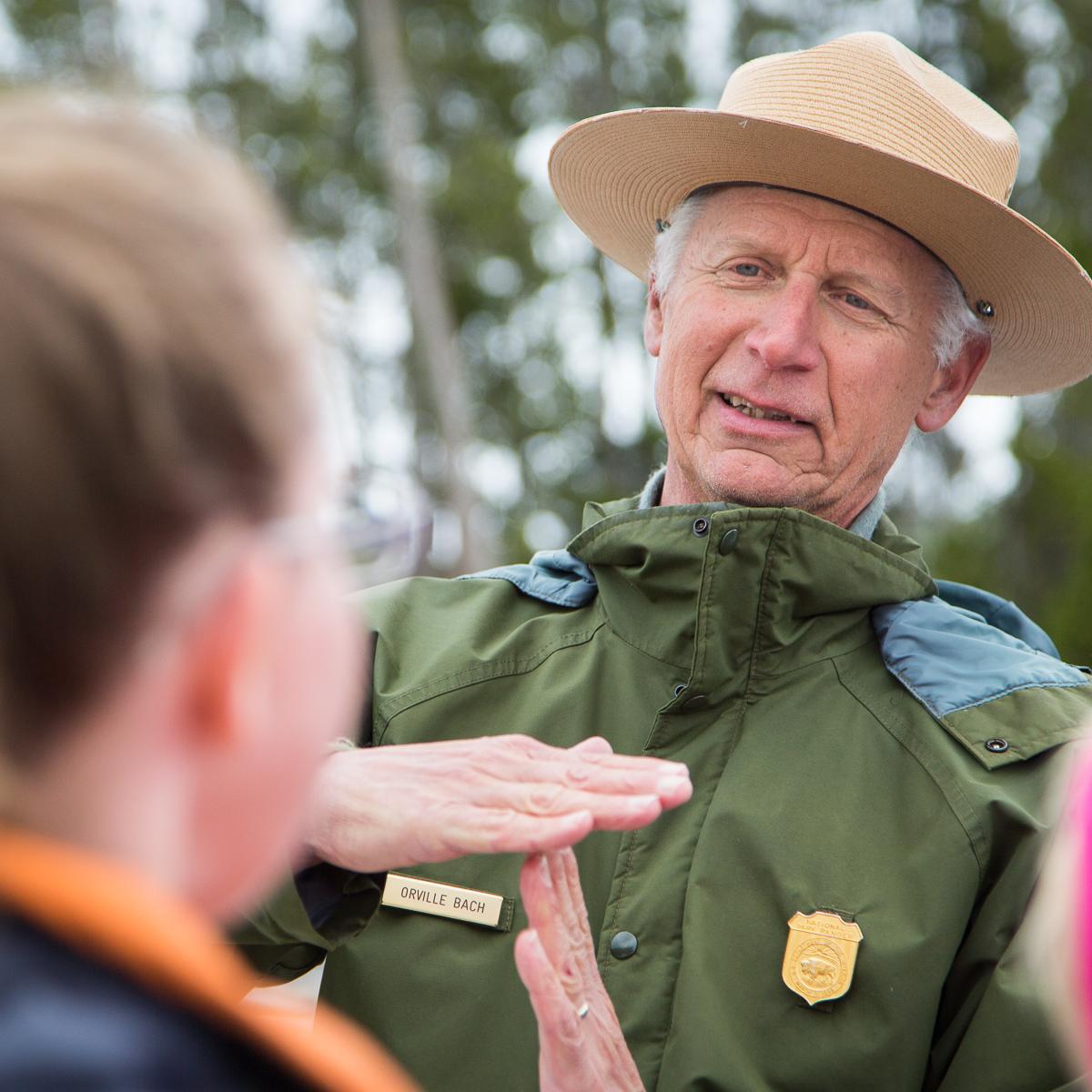 A ranger answers questions after an eruption of Old Faithful.