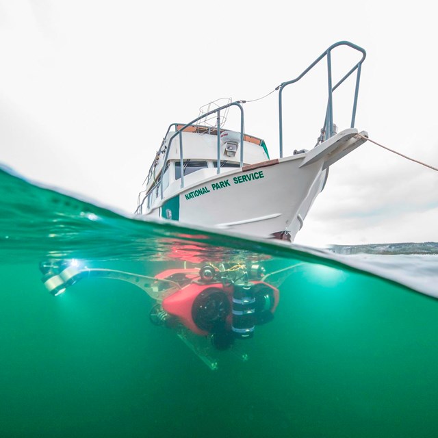 An NPS boat seen above a submersible in the water