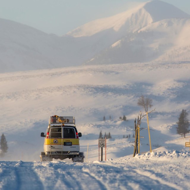 A snowcoach on winter road.