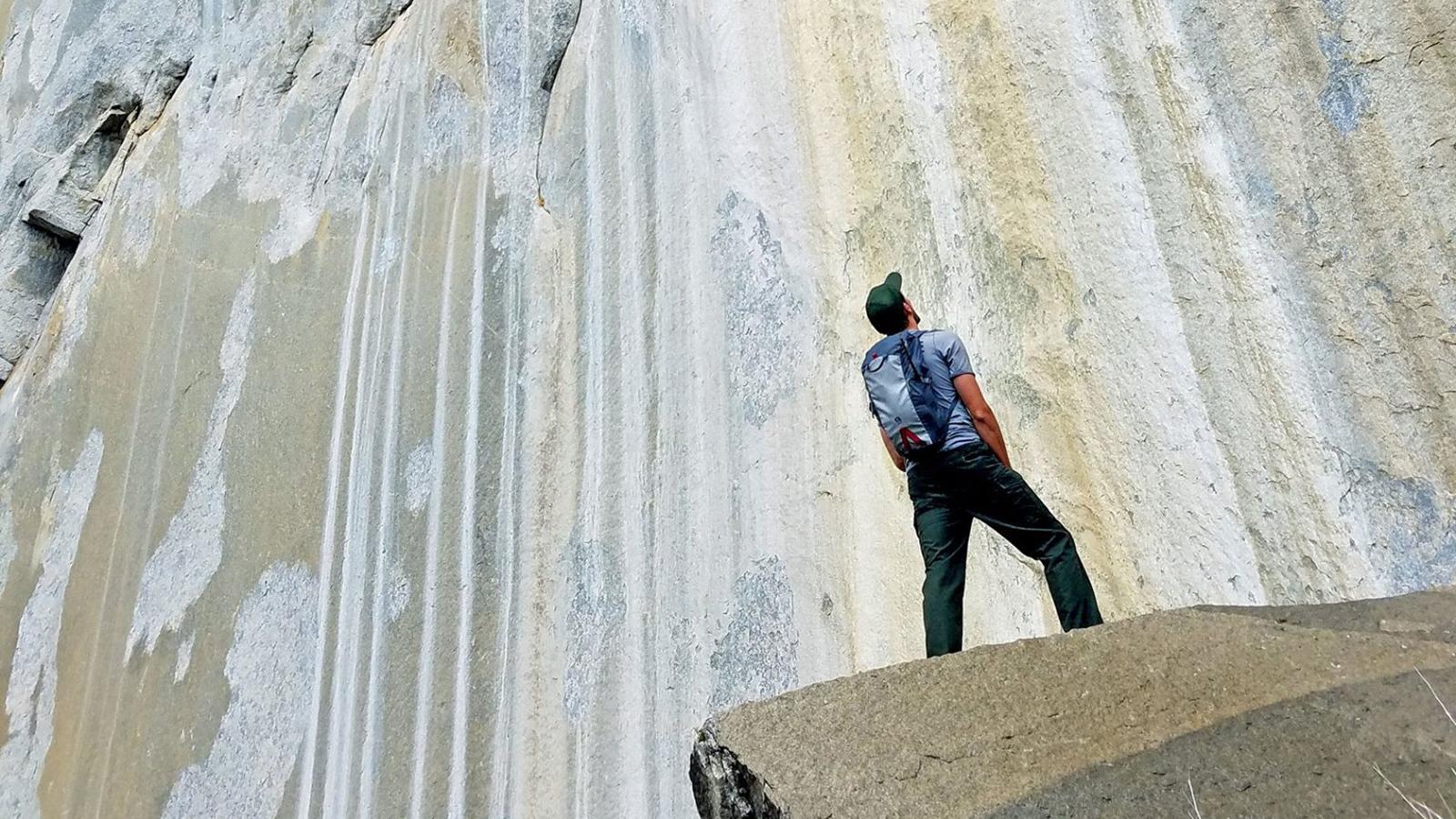 Climbing ranger looking up at big wall