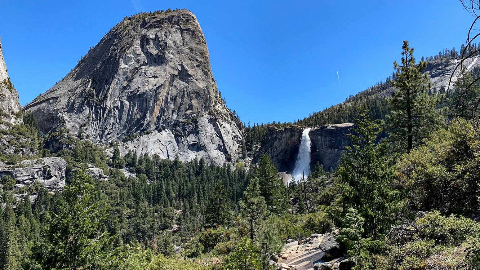 Liberty Cap and Nevada Fall in the distance, with a trail in the foreground
