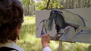 Artist painting a picture of Half Dome
