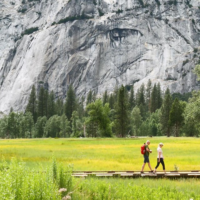 Two hikers on a boardwalk in Yosemite Valley