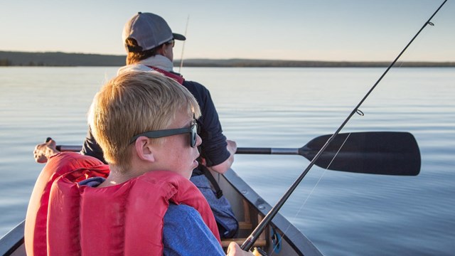 Two people fishing in a canoe