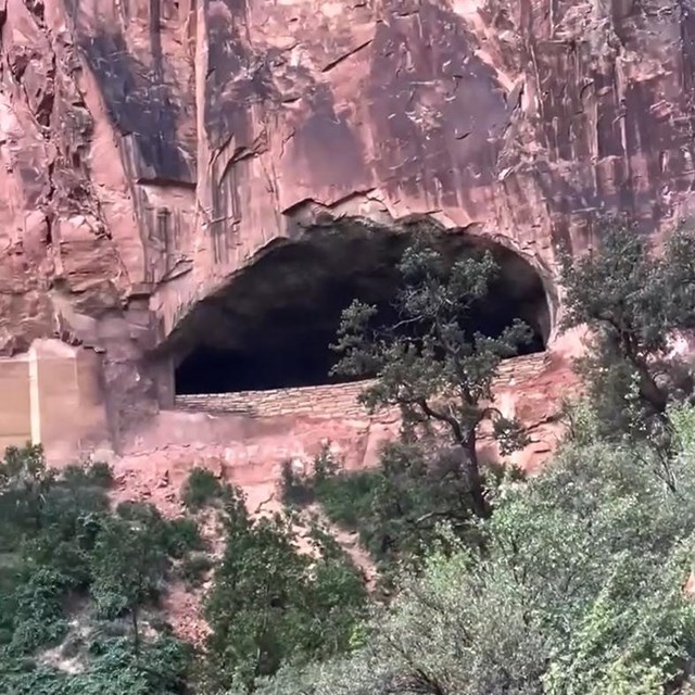 A large tunnel window carved into the side of a mountain.