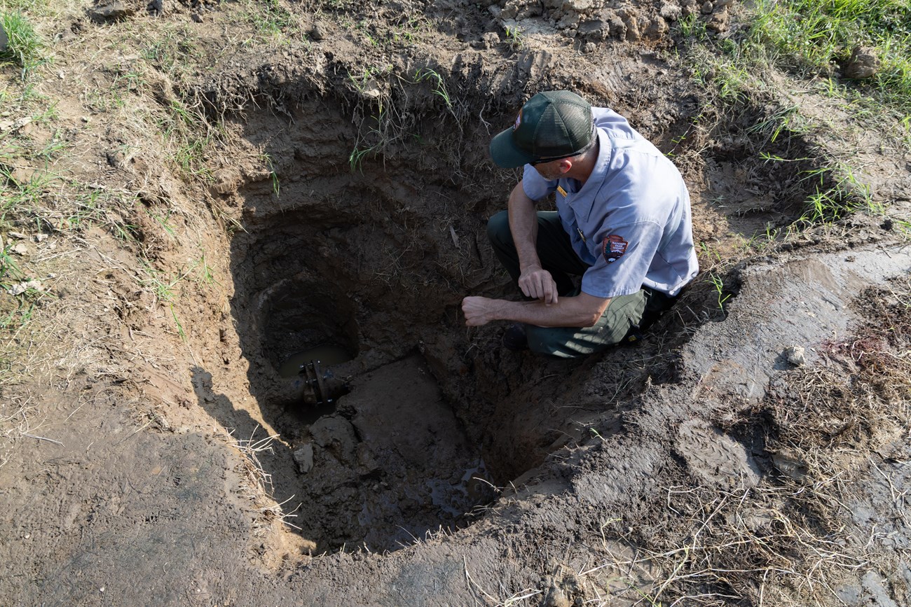 National Park Service Chief of Maintenance Scott Sommers observes a broken sprinkler system at The W