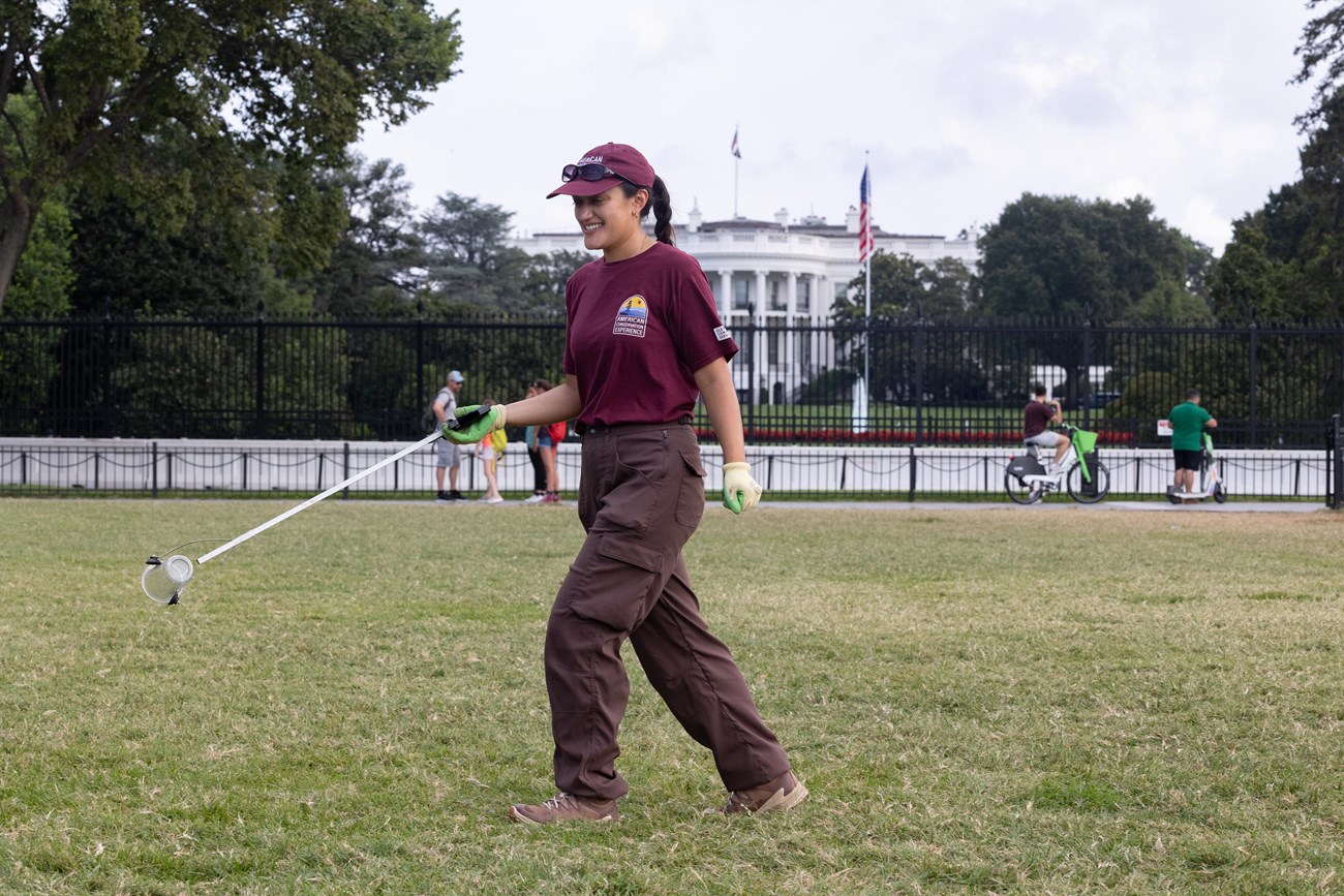 Traditional Trades Advancement Program (TTAP) intern Kendall Soriano removes trash near the White Ho