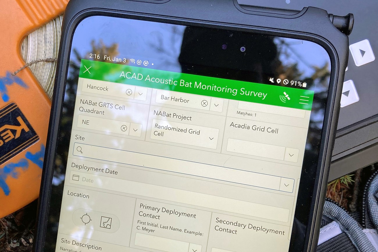 Tablet atop a pile of field gear, with a form onscreen titled 