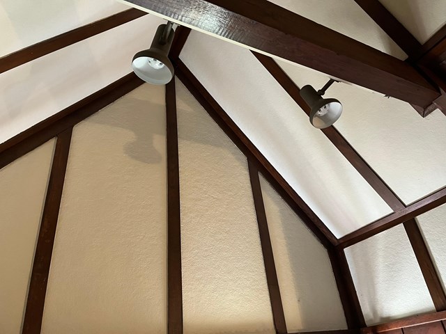 close up of wood beams and wood accents along the ceiling and walls