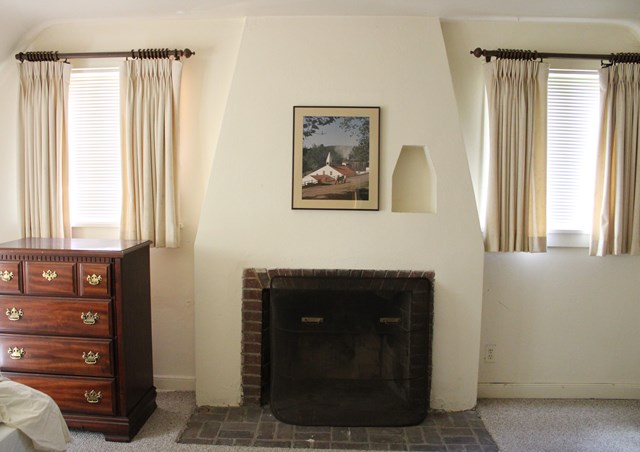 a fireplace and with windows on either side