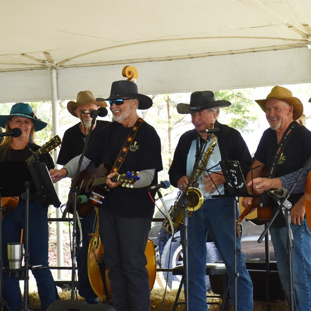 A group of musicians on stage performing.