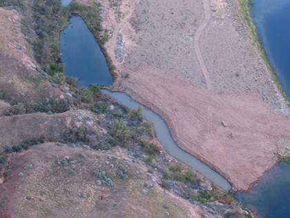 Aerial view of a river in a canyon with a channel cut into a gravel bar