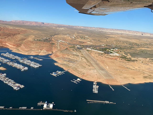 Aerial view of a desert lake with many boats in a marina
