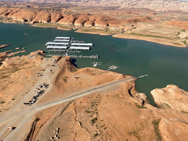 Aerial view of launch ramp leading into a desert lake near a marina.
