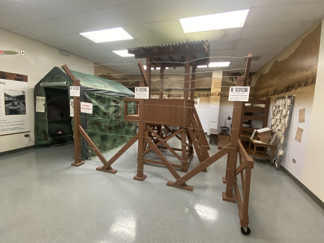 A replica guard tower with a tent next to it.