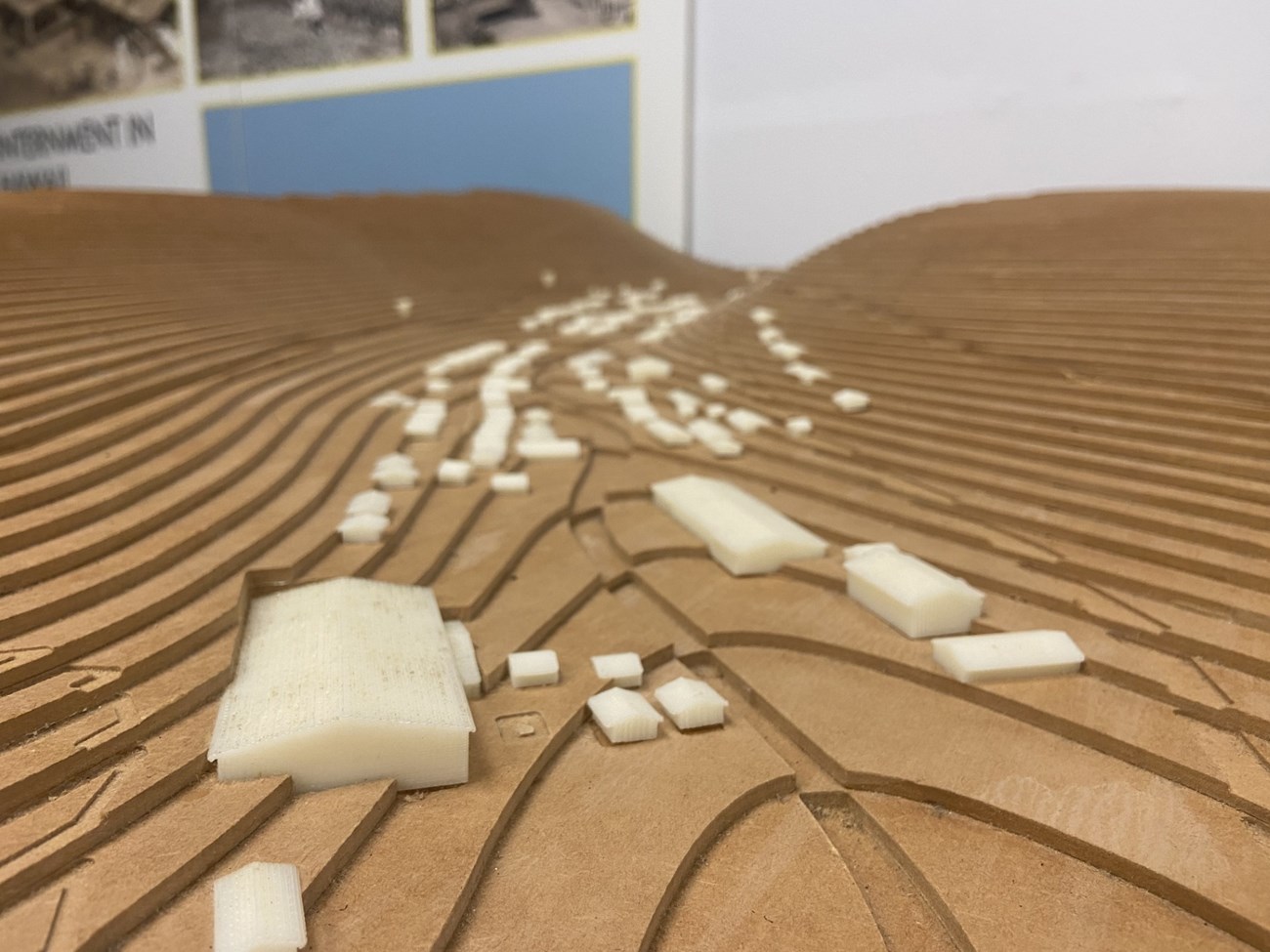 Small white buildings in a topographic map of a valley